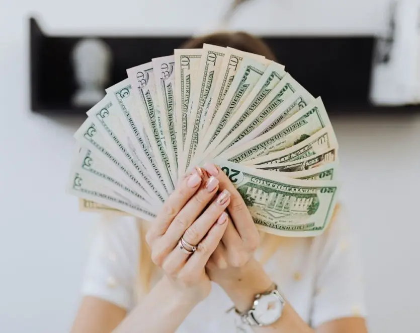 Person Holding Fan Of Cash Money